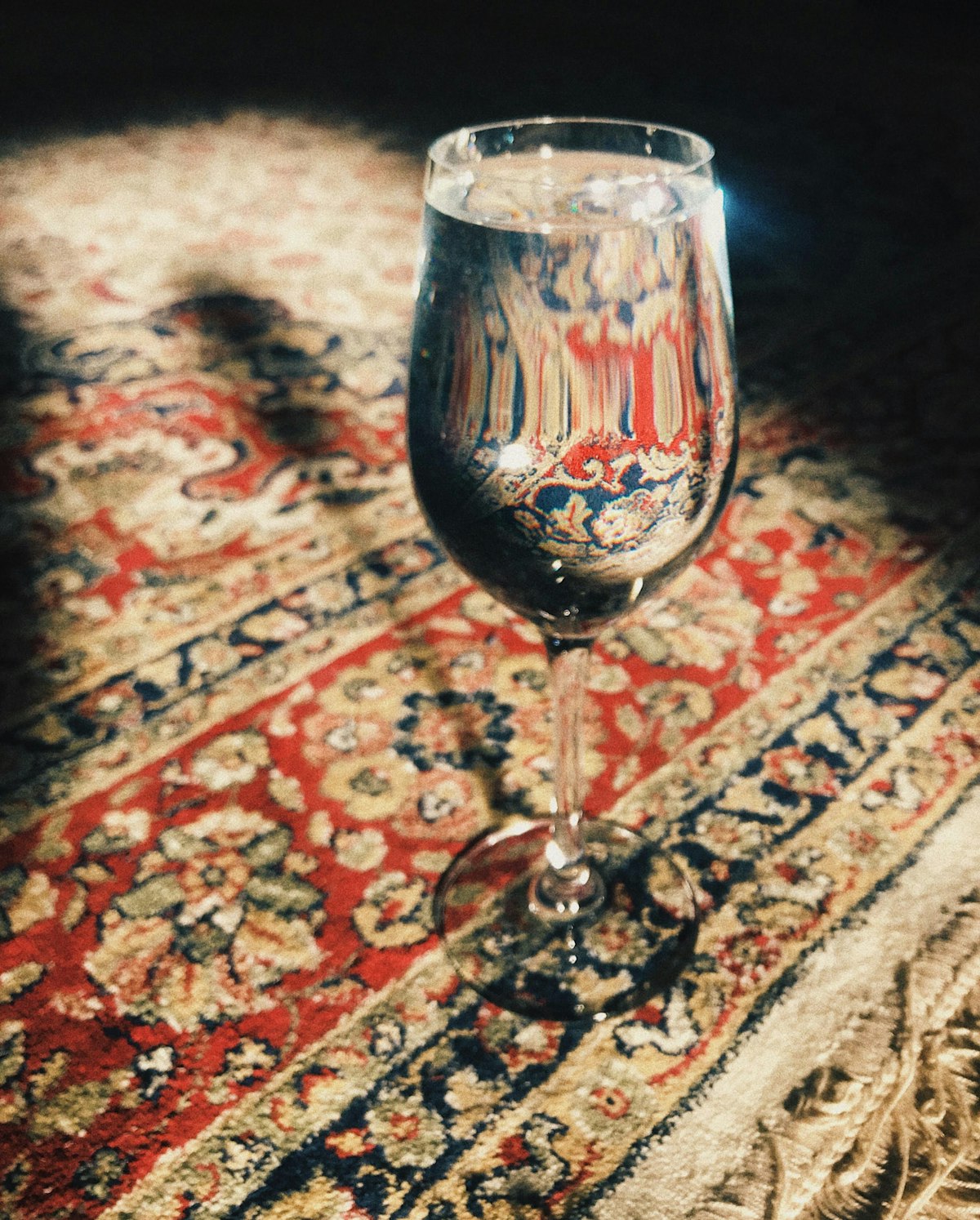 Wine glass on a patterned carpet